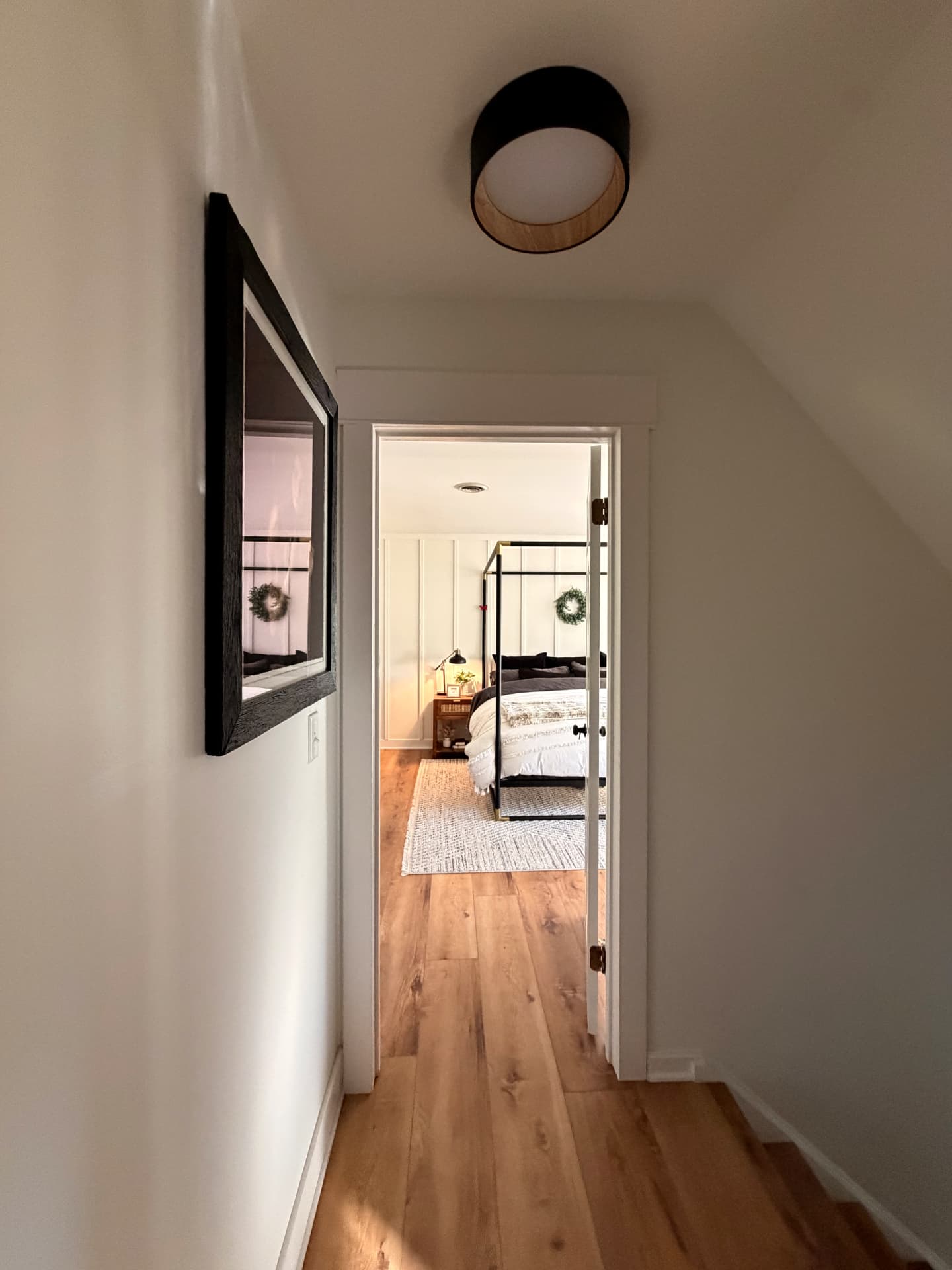 Hallway leading to a bedroom with matching oak flooring