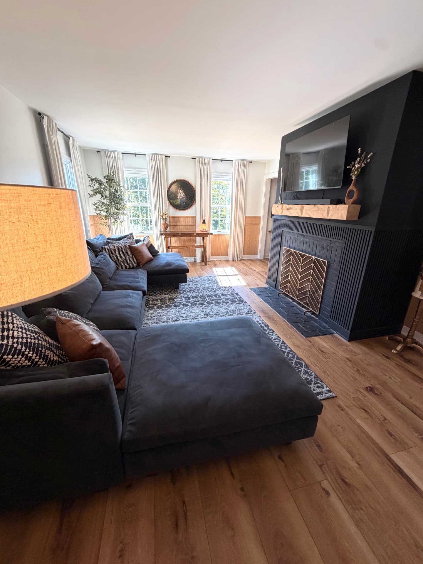Living room with dark fireplace and warm oak flooring
