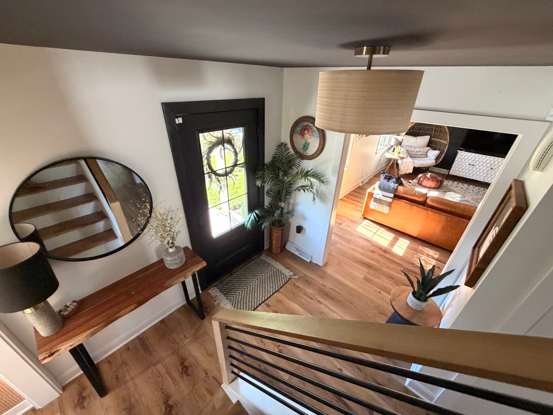 Entryway viewed from the staircase with continuous oak flooring
