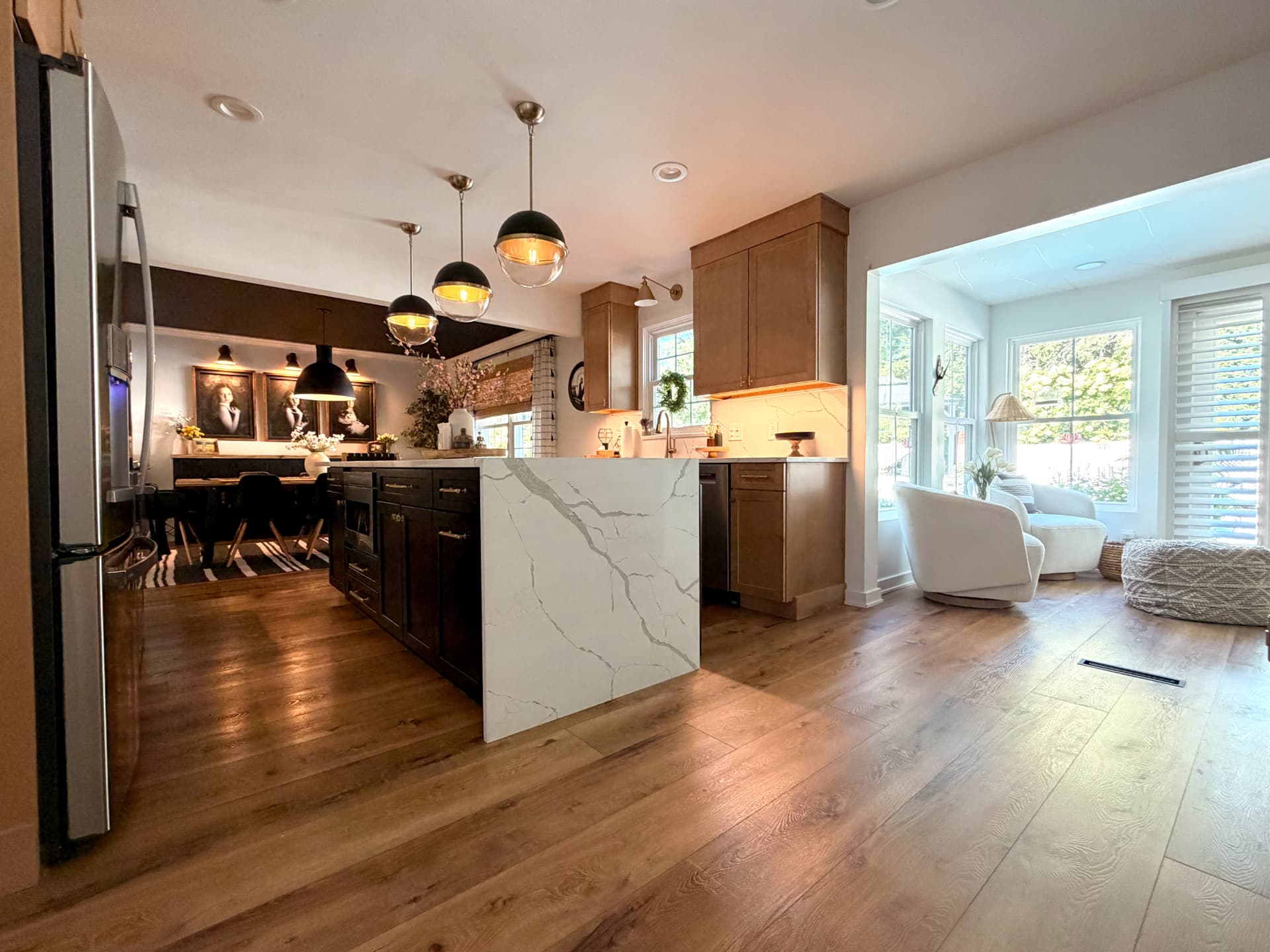Kitchen and sunroom joined by continuous oak flooring